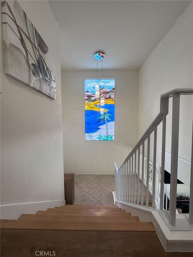 stairway with tile patterned flooring