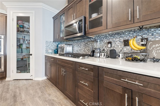 20900 Center St, Riverside, CA 92507 - kitchen with stainless steel appliances, tasteful backsplash, light countertops, glass insert cabinets, and ornamental molding