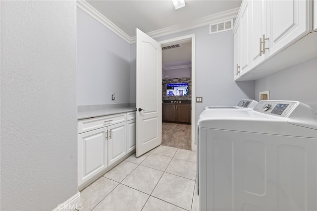 20900 Center St, Riverside, CA 92507 - laundry room featuring crown molding, cabinet space, separate washer and dryer, and light tile patterned floors