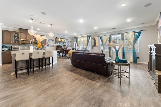 20900 Center St, Riverside, CA 92507 - living area featuring ornamental molding, recessed lighting, wood finished floors, and a fireplace