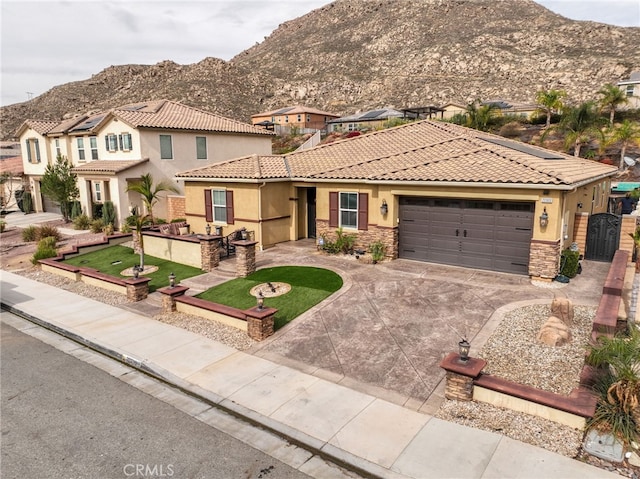 20900 Center St, Riverside, CA 92507 - mediterranean / spanish house featuring a mountain view, stucco siding, stone siding, and driveway