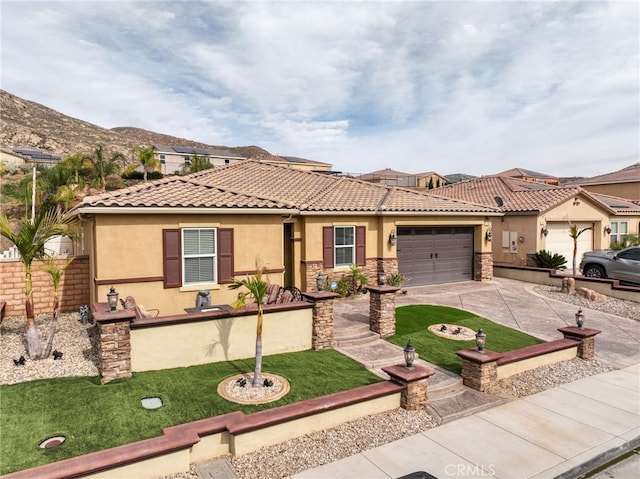 20900 Center St, Riverside, CA 92507 - view of front of house with stucco siding, concrete driveway, a garage, a tile roof, and stone siding