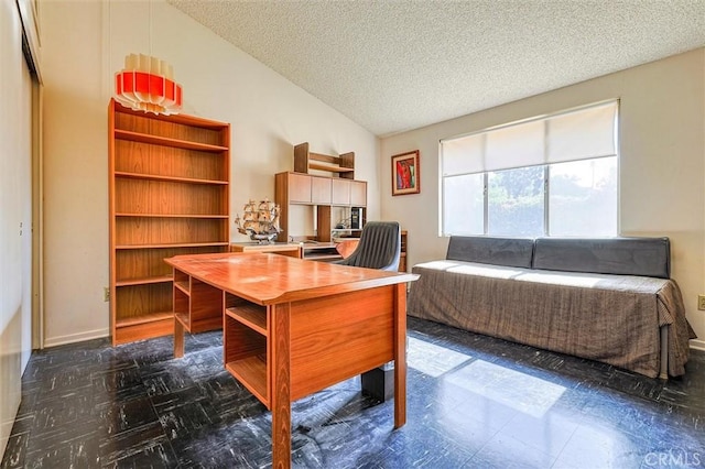 home office with lofted ceiling and a textured ceiling