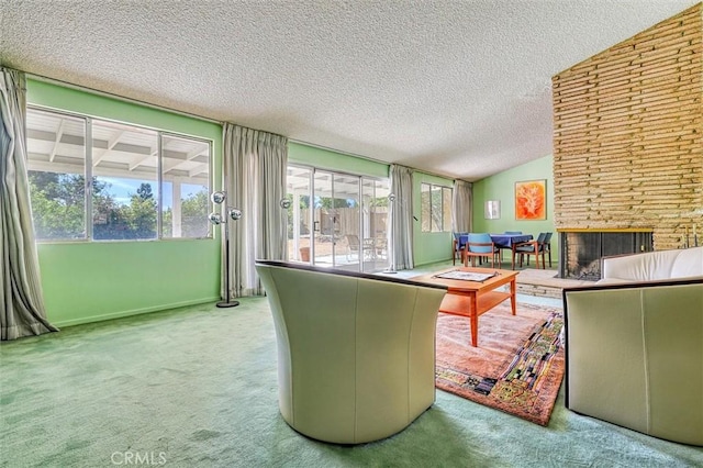 carpeted living area with lofted ceiling, a brick fireplace, and a textured ceiling