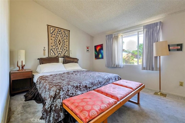 bedroom featuring carpet floors, lofted ceiling, and a textured ceiling