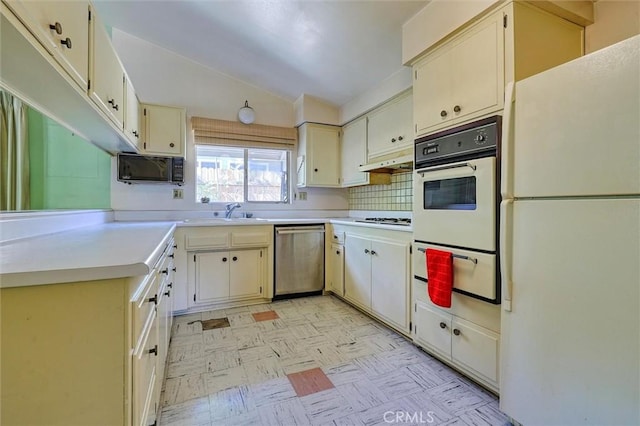 kitchen featuring white appliances, light countertops, light floors, a sink, and a warming drawer