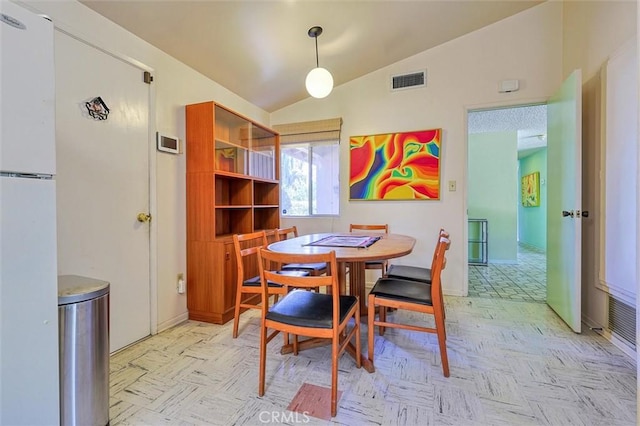 dining space featuring visible vents and vaulted ceiling