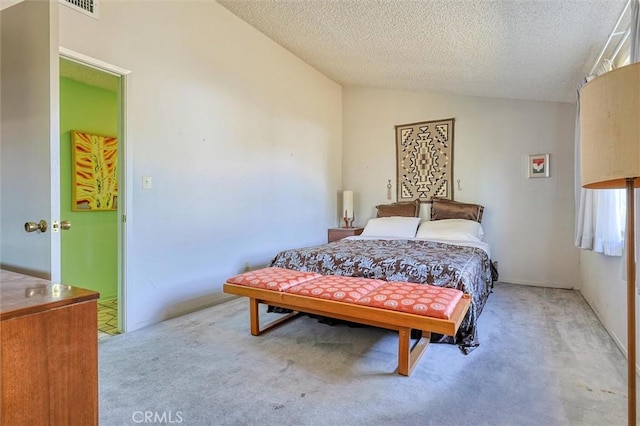 carpeted bedroom with lofted ceiling and a textured ceiling