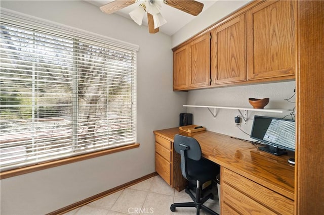 office area with light tile patterned floors, ceiling fan, and baseboards