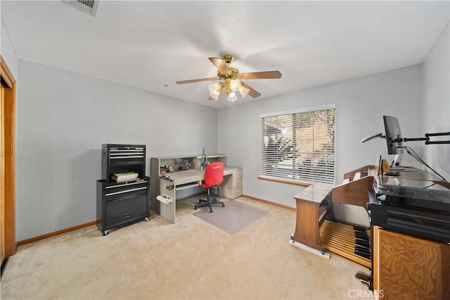 office area with baseboards, a ceiling fan, and light colored carpet