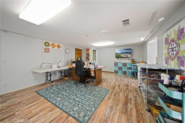 office space with wood finished floors and visible vents