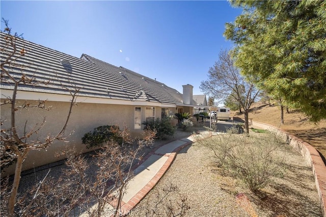 view of side of home featuring a patio and stucco siding