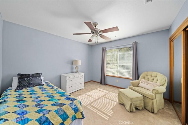 carpeted bedroom with a ceiling fan and baseboards