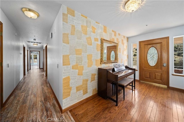 entryway featuring hardwood / wood-style floors and baseboards