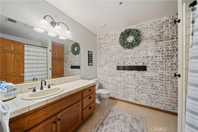 full bath featuring toilet, vanity, visible vents, and tile patterned floors