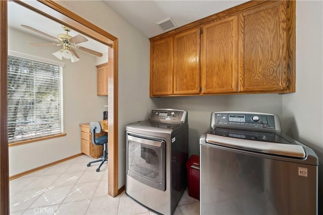 washroom featuring visible vents, cabinet space, ceiling fan, washer and dryer, and baseboards