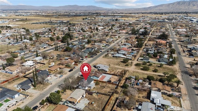 drone / aerial view with a residential view, a mountain view, and a desert view