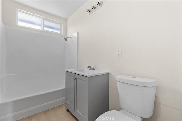 bathroom featuring shower / bath combination, vanity, toilet, and wood finished floors