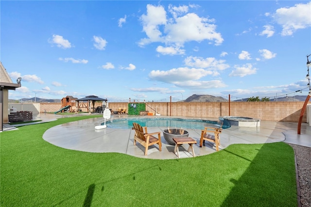 view of yard featuring a patio, a fire pit, and a fenced backyard