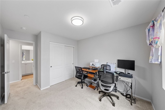 carpeted office featuring visible vents and baseboards