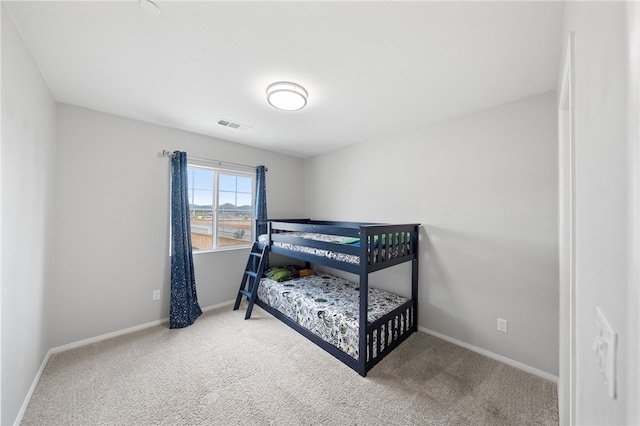 bedroom with visible vents, baseboards, and carpet flooring