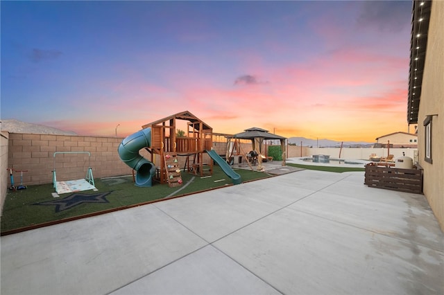 view of jungle gym with a gazebo, a fenced backyard, and a patio area