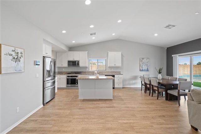 kitchen with visible vents, white cabinetry, stainless steel appliances, and light wood-type flooring