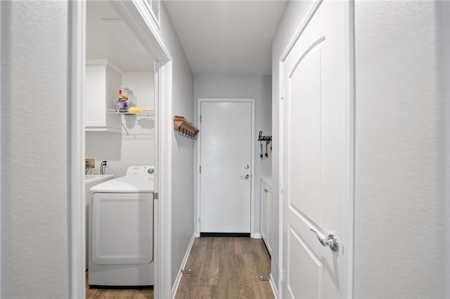 laundry room featuring cabinet space, washer / clothes dryer, and wood finished floors