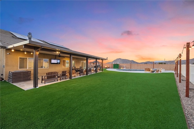 view of yard featuring ceiling fan, a fenced in pool, a patio, and a fenced backyard