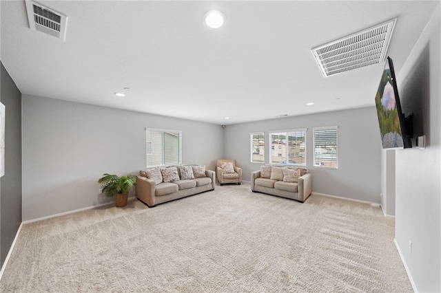 unfurnished living room featuring recessed lighting, visible vents, baseboards, and carpet