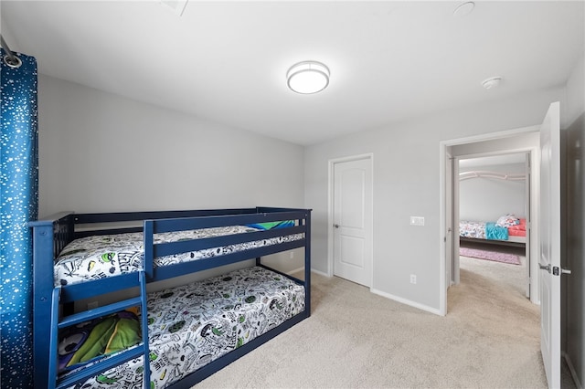 carpeted bedroom featuring baseboards