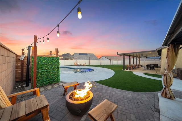 view of patio featuring a fire pit, a fenced in pool, and a fenced backyard