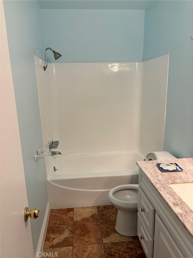 bathroom featuring toilet, shower / tub combination, baseboards, and vanity