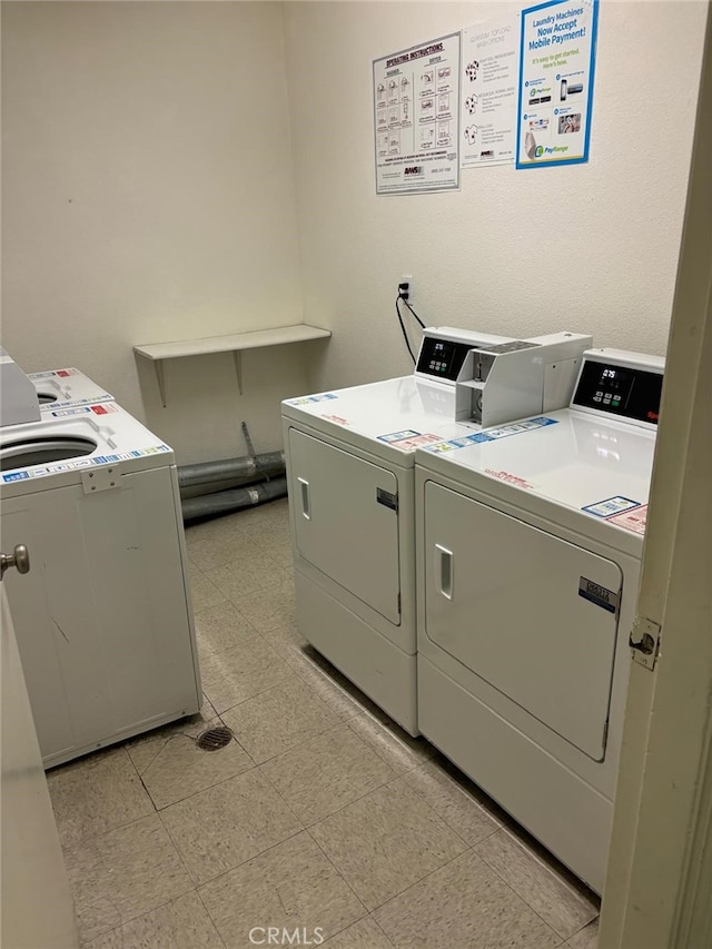 community laundry room with light floors and washing machine and dryer