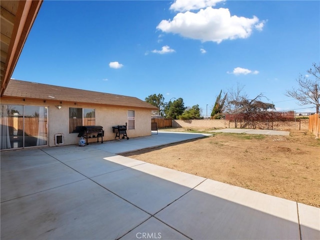 exterior space with fence and area for grilling