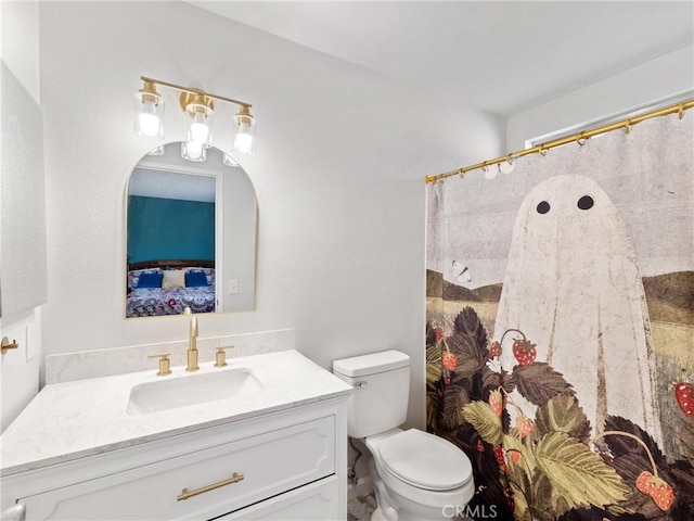 bathroom with toilet, vanity, and a shower with curtain