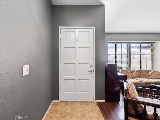 entrance foyer featuring tile patterned flooring and baseboards