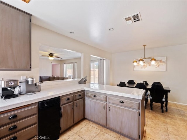 kitchen featuring tile counters, visible vents, a peninsula, and light tile patterned flooring