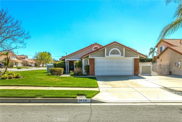 view of front of house featuring driveway, a garage, a gate, a front yard, and brick siding