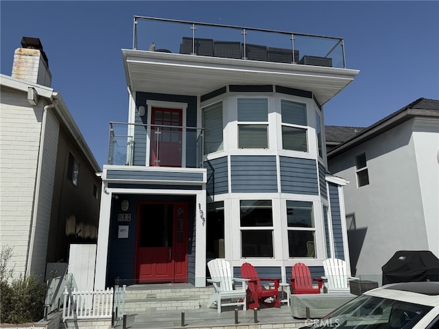 view of front of house featuring a balcony