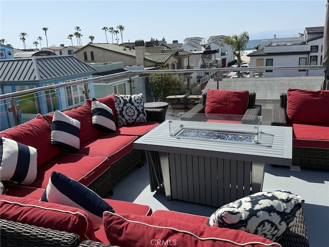 view of patio featuring a residential view, an outdoor living space with a fire pit, and a balcony