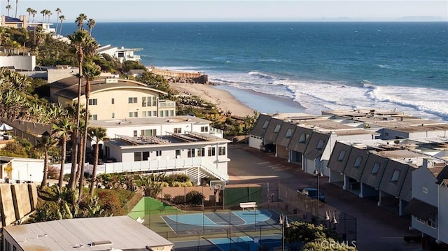 birds eye view of property with a water view and a beach view