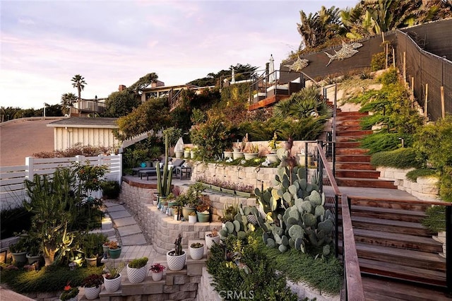 view of yard featuring fence, stairway, and a patio