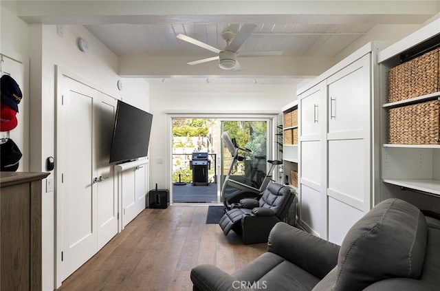 living room featuring dark wood-style floors, ceiling fan, and beam ceiling