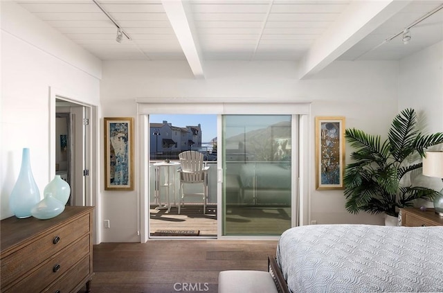 bedroom featuring access to exterior, beam ceiling, rail lighting, and wood finished floors