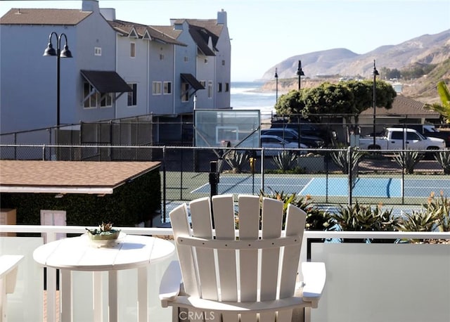 balcony featuring basketball hoop and a mountain view