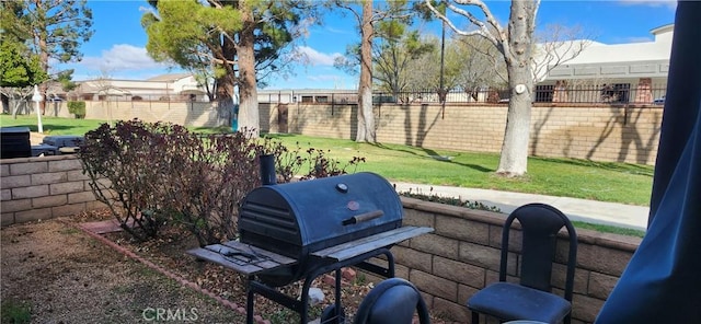 view of patio with a fenced backyard and a grill