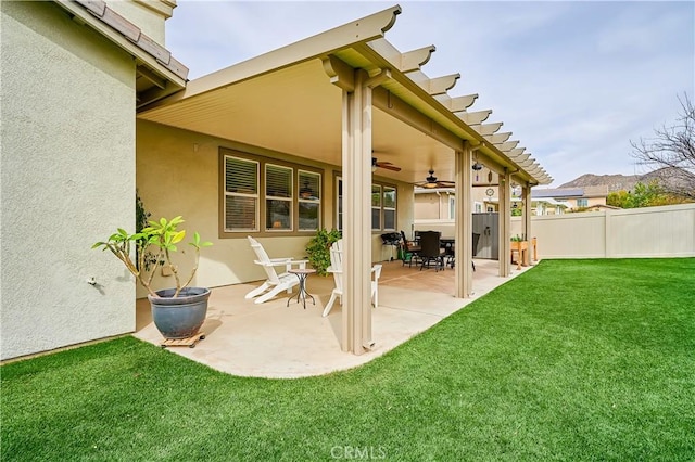 exterior space featuring a ceiling fan and fence