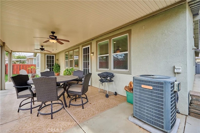 view of patio / terrace with ceiling fan, fence, central AC, and outdoor dining space