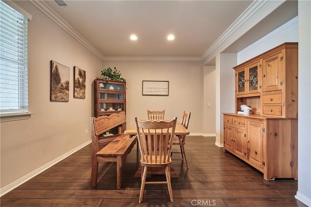 dining space featuring baseboards, dark wood-style flooring, and crown molding